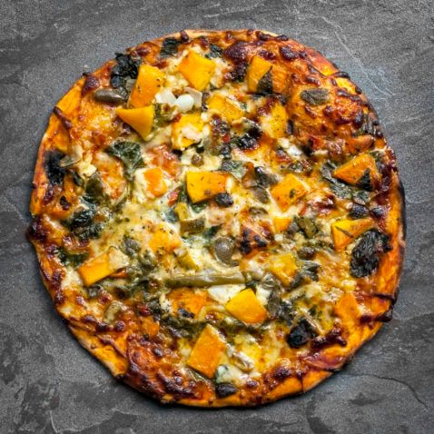 Vegetarian pizza, top view on slate. 