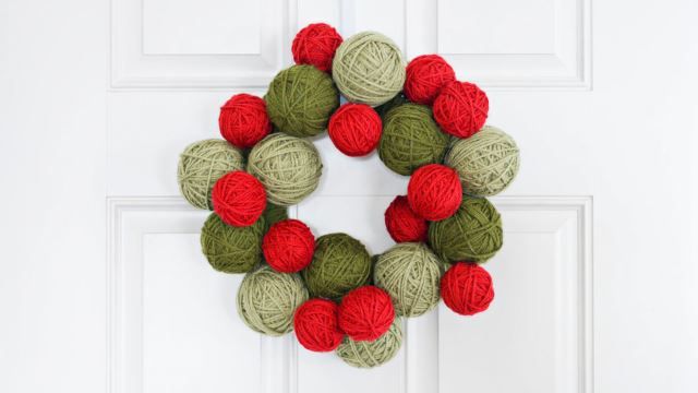 Beautiful Knitted Wreath Balls On A White Painted Door