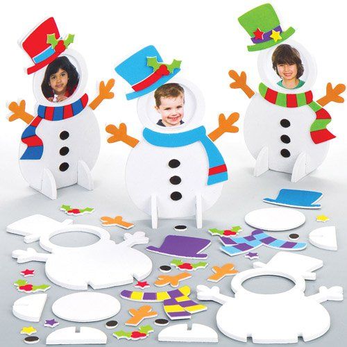 Three snowman assembled with faces on its head and several pieces laid down