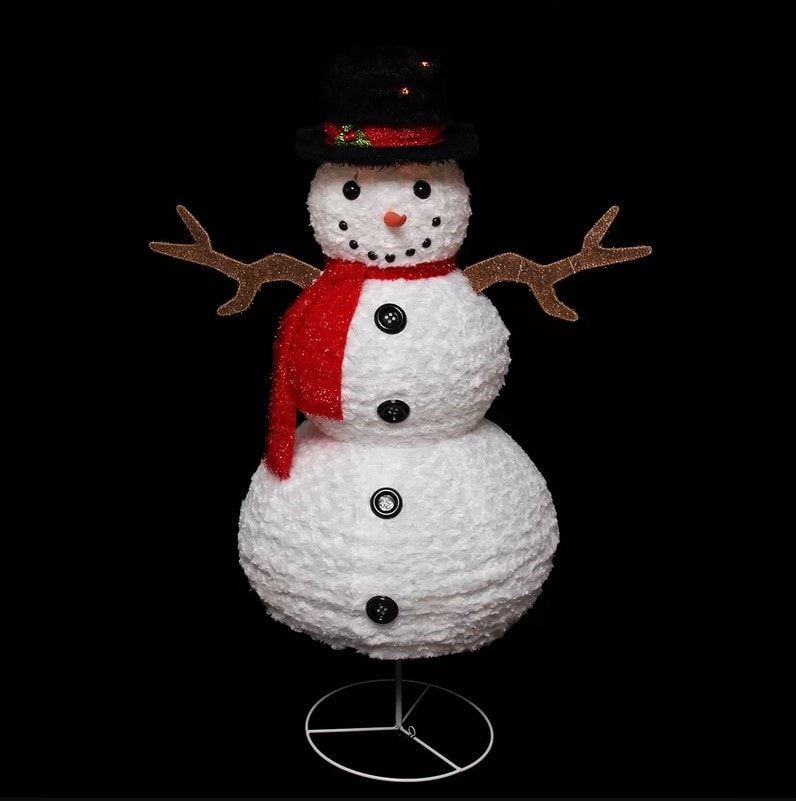 Snowman made from chenille fabric with diy wooden inspired arms created with a stand