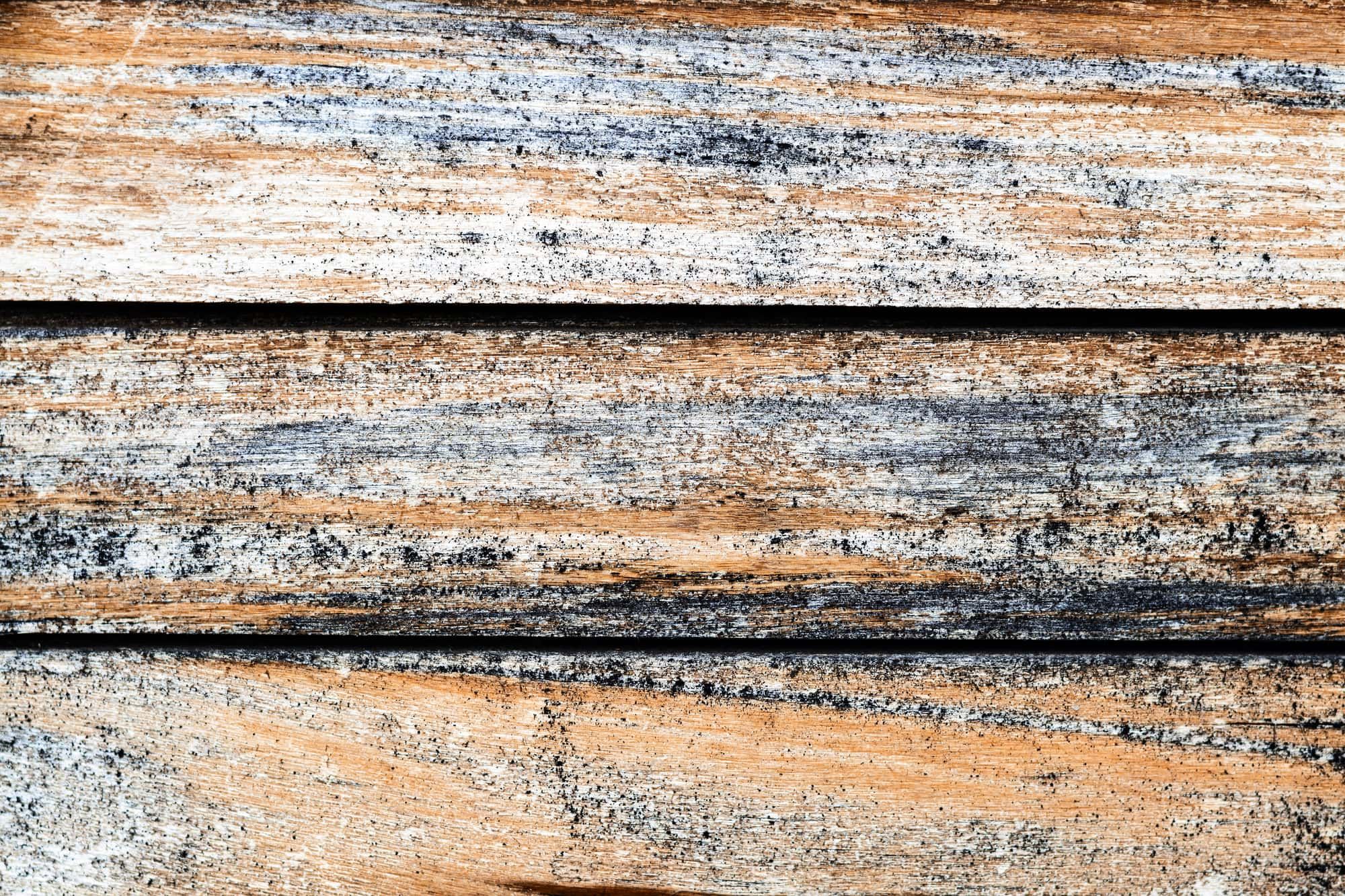 Weathered old striped texture of wooden boards-a natural background pattern of treated wood
