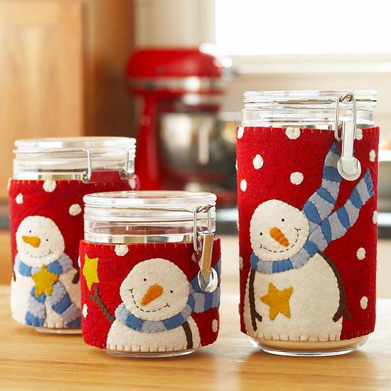 Three jars adorned its body with clothings that has smiling snowman as its design