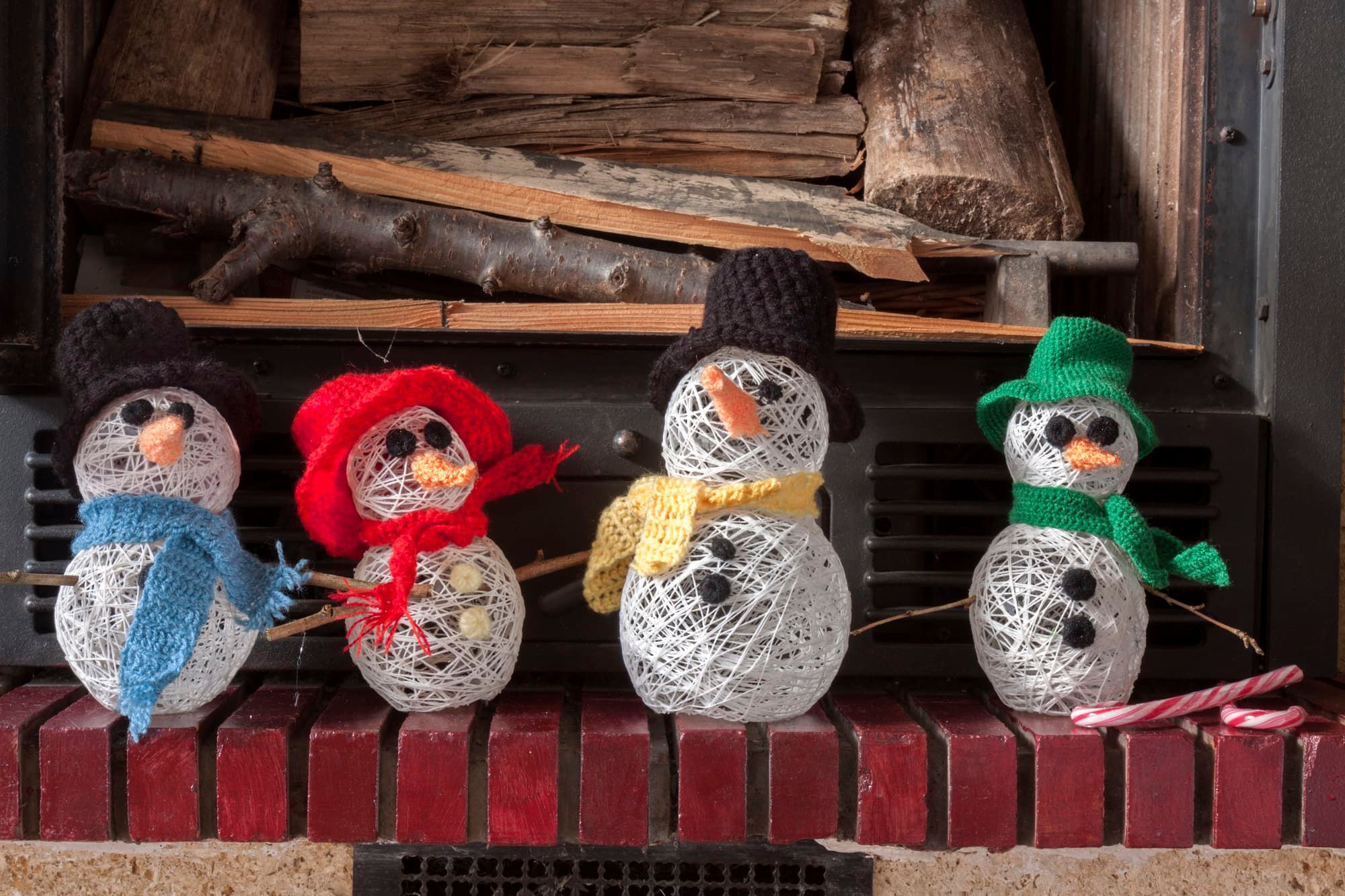 a horizontal frontal view of a decorated fireplace with snowmen