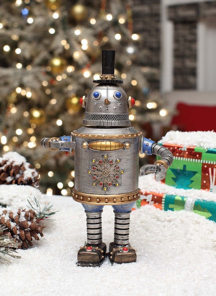 Snowman inspired made of tin can with snowflake design on its belly and wearing a little black hat standing on a snow