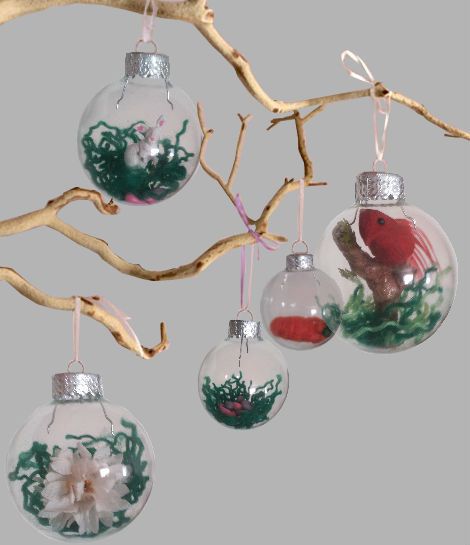 Christmas tree transparent balls hanging on twigs with artificial plants inside
