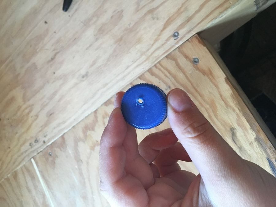 A hole poked on a plastic cap.