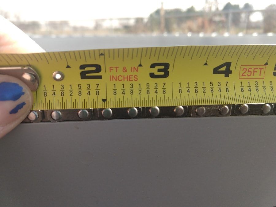 Chainsaw measured by a measuring tape on its top