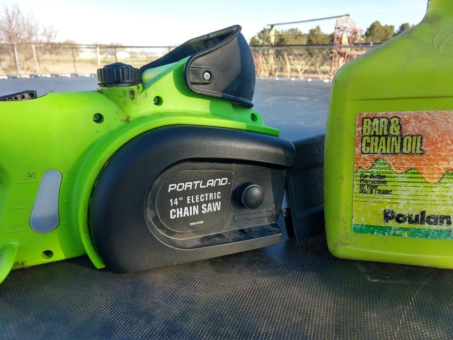 Green 14&quot; Portland Chainsaw and a gallon of bar and chain oil.