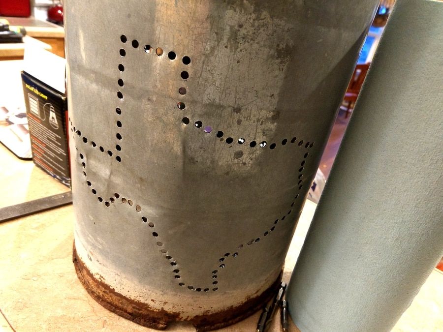 a metal container with a lot of holes that forms a pattern
