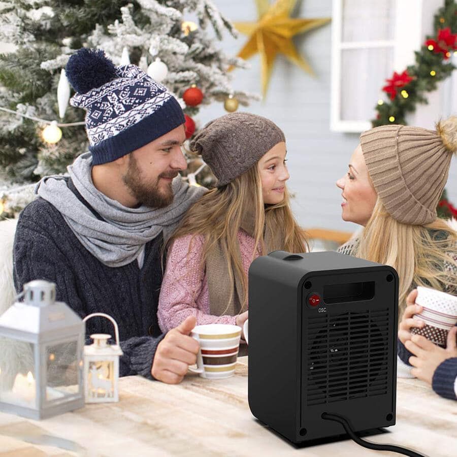 a family with a portable space heater in a table
