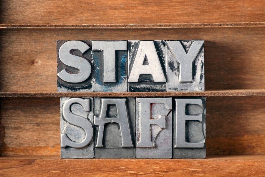 stay safe phrase made from metallic letterpress type on wooden tray