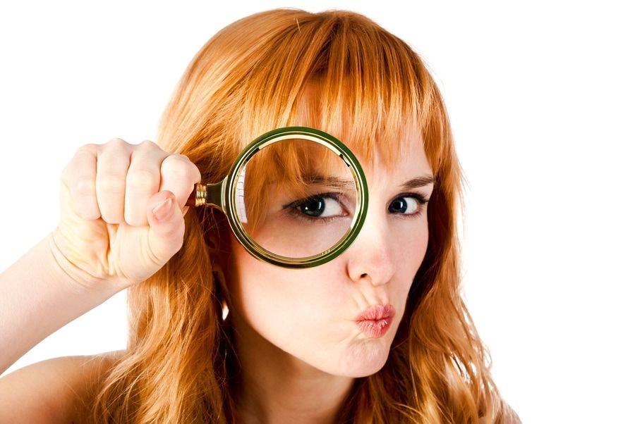 woman with magnifying glass isolated on a white background