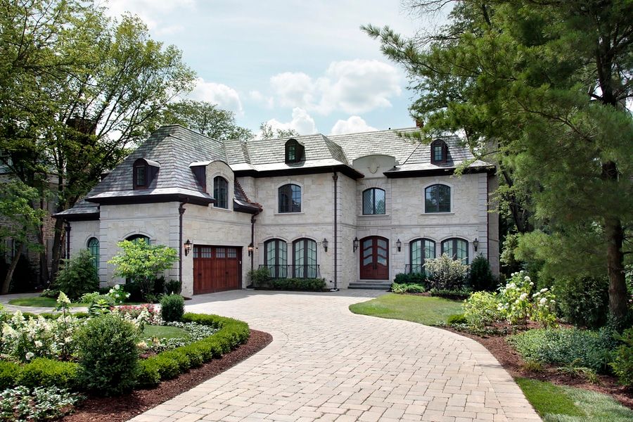 Front view of luxury home with circular driveway