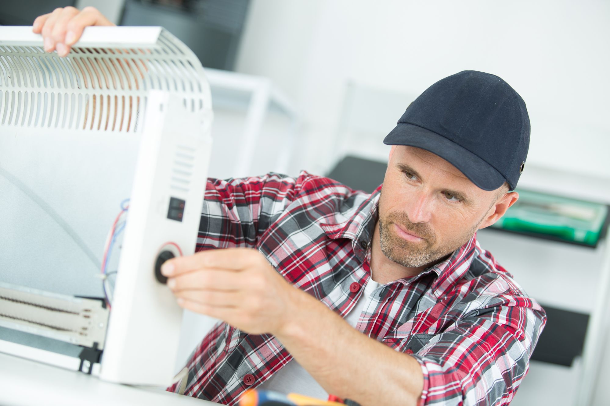 Electrician repairing heater and repair
