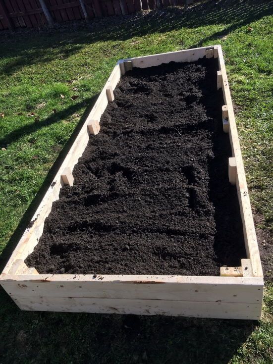 wooden box with soil on the ground