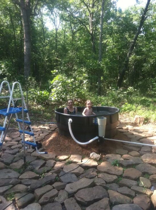 mother and baby inside a Redneck Outdoor Tub with trees at the back