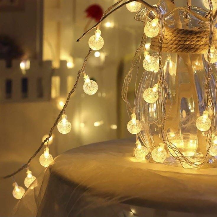 A jar place on the table with Globe Lights