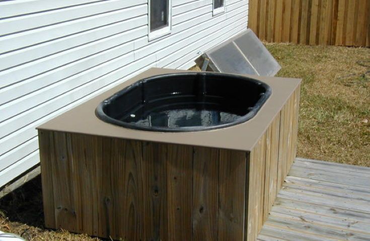 wooden frame hot tub on the backyard