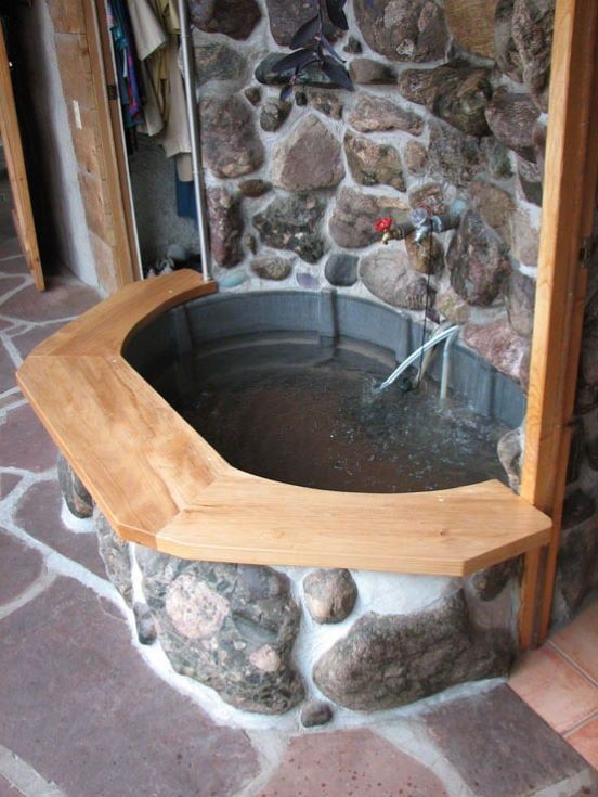 A Solar Home Spa and Fountain made of wood, large stones and bricks,