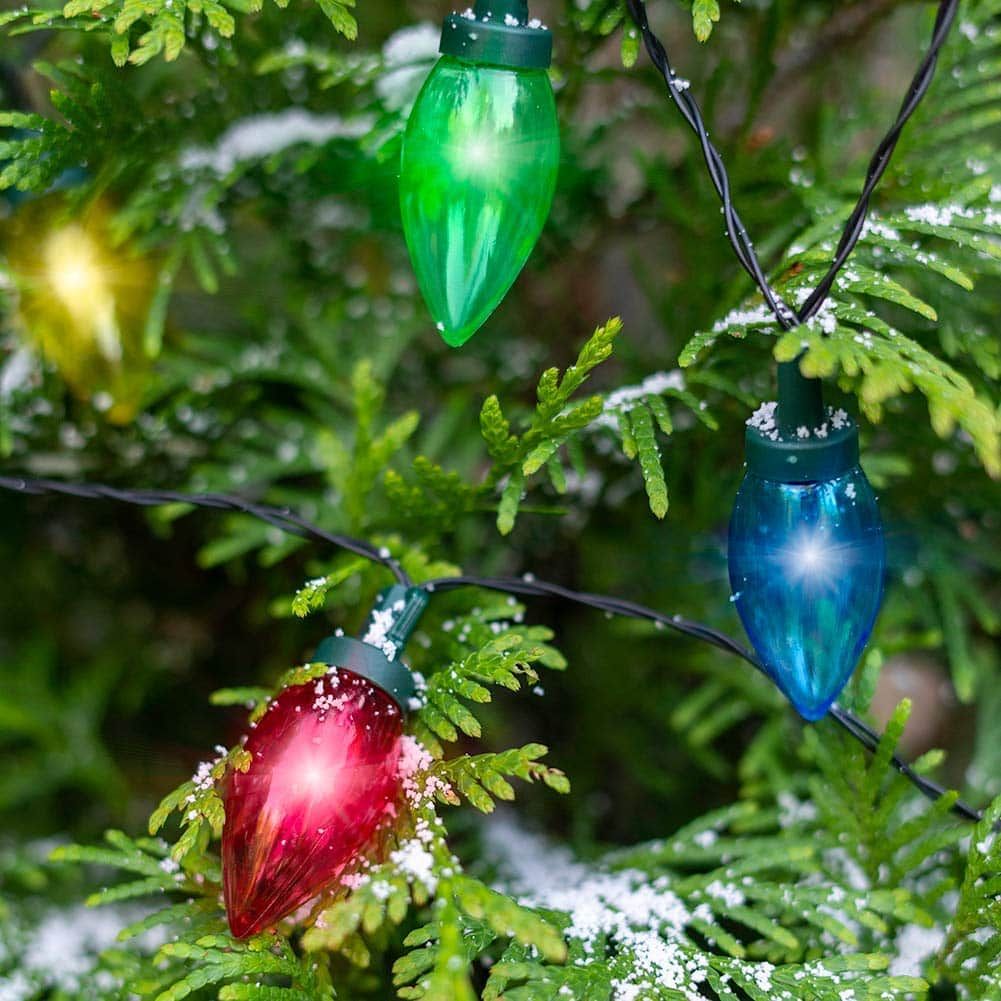 Touch Of ECO Solar LED Christmas Bulb String Lights in red,green,blue and yellow decorated on a christmas tree.