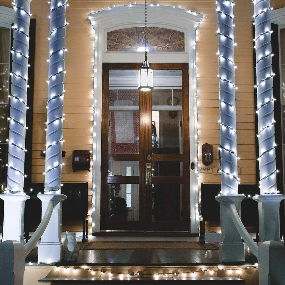 White lit string of lights decorated on front door post and pillars.