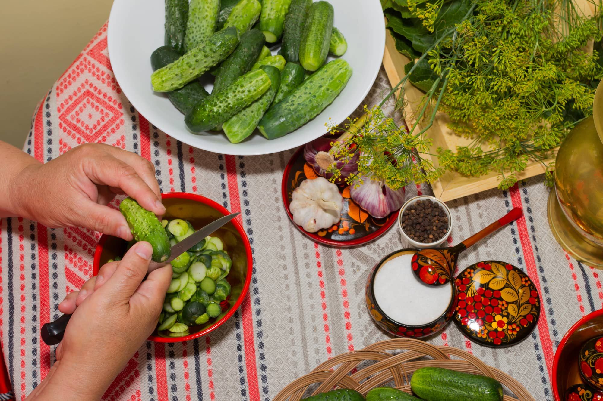 Pickling cucumbers, pickling - hands close-up, cucumber, herbs, spices, salt, hohloma, Russian style. Recipes, step execution. Harvesting vegetables in store.