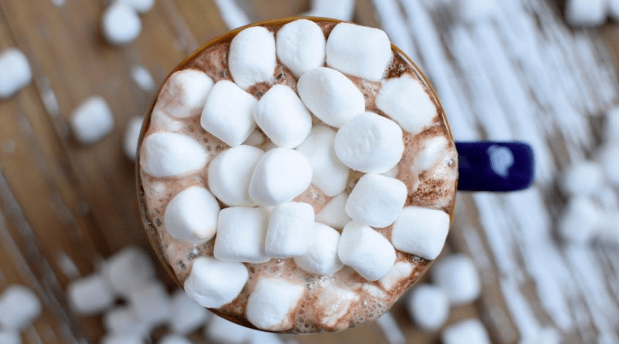 hot chocolate cocoa from above with marshmallows on a wooden table