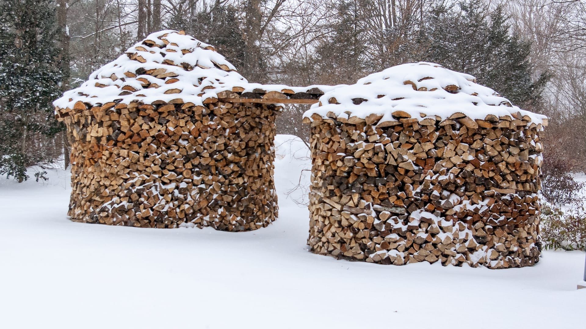 holz hausen firewood stacks in snowy outdoors
