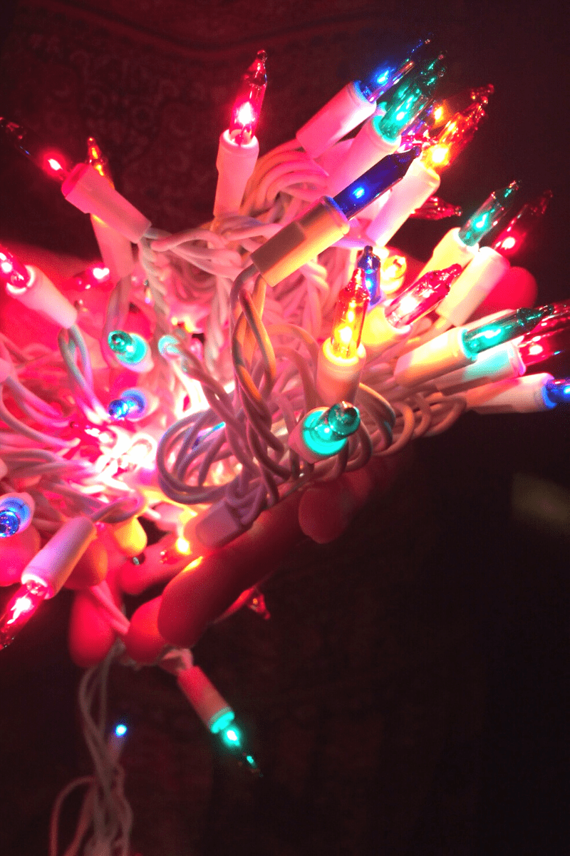 closeup of multicolor incandescent christmas lights in the dark