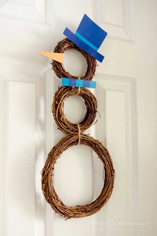 An easy snowman made from grapevine wreaths and chipboard.