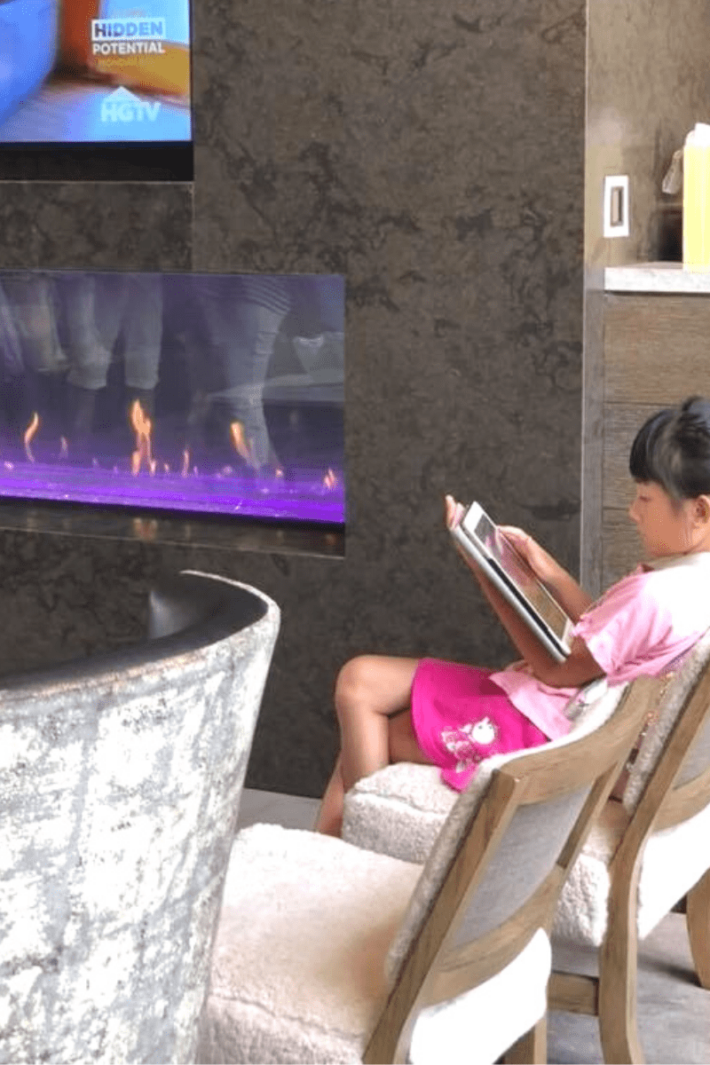 tv over electric fireplace girl reading