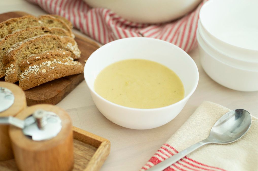 creamy root vegetable puree in bowl with bread