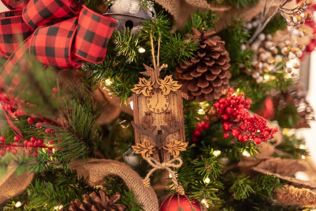 rustic miniature wooden cuckoo clock hanging on the Christmas tree 