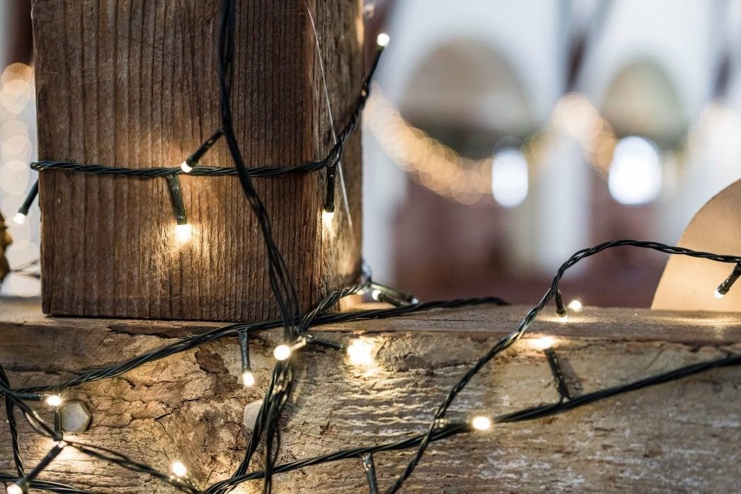 closeup of wood with string lights on it