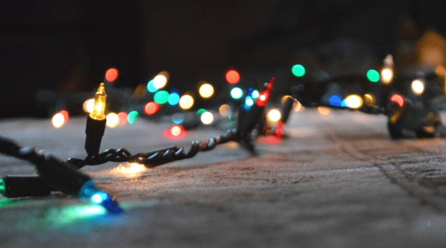a string of multicolor incandescent christmas lights on the rug