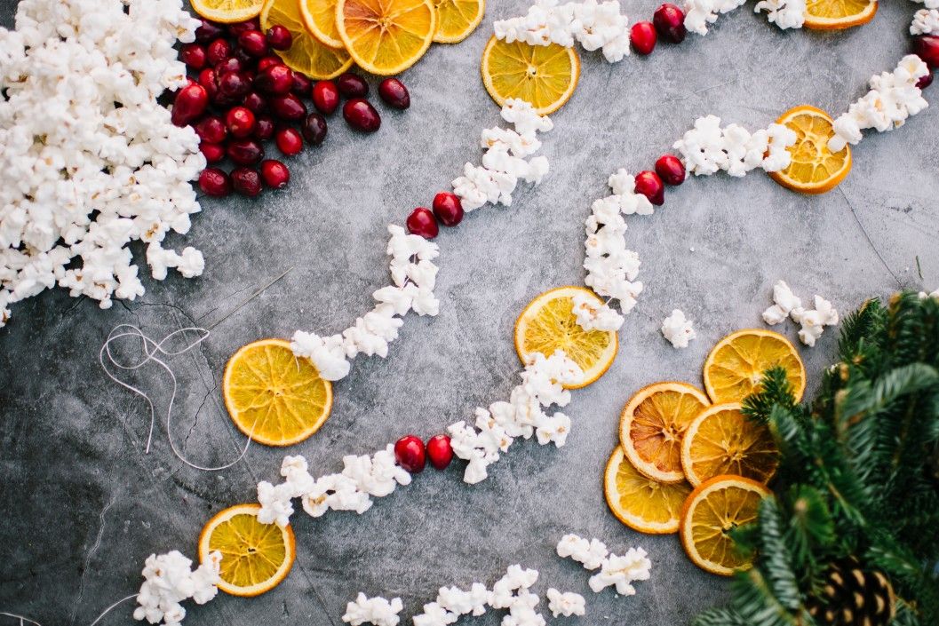 Holiday Christmas Flat Lay garland of cranberry popcorn dried oranges citrus rustic natural