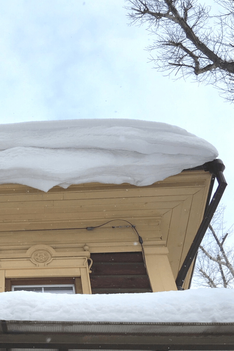 snow buildup on second story roof of home from below