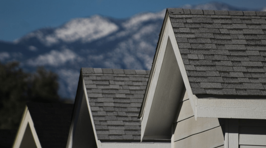 shingled rooftops with mountain background
