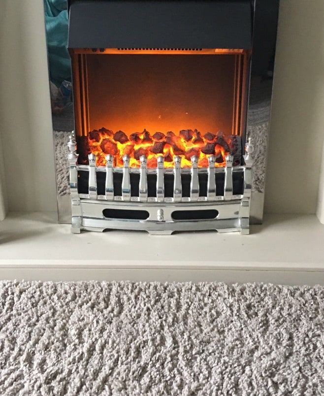 Lovely living room heater, chrome with lots of Orange Coals burning bright creating soft glow