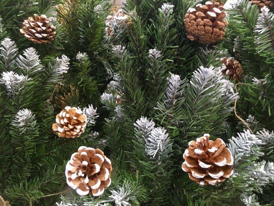 pine cone christmas tree closeup of flocked branches and ornaments