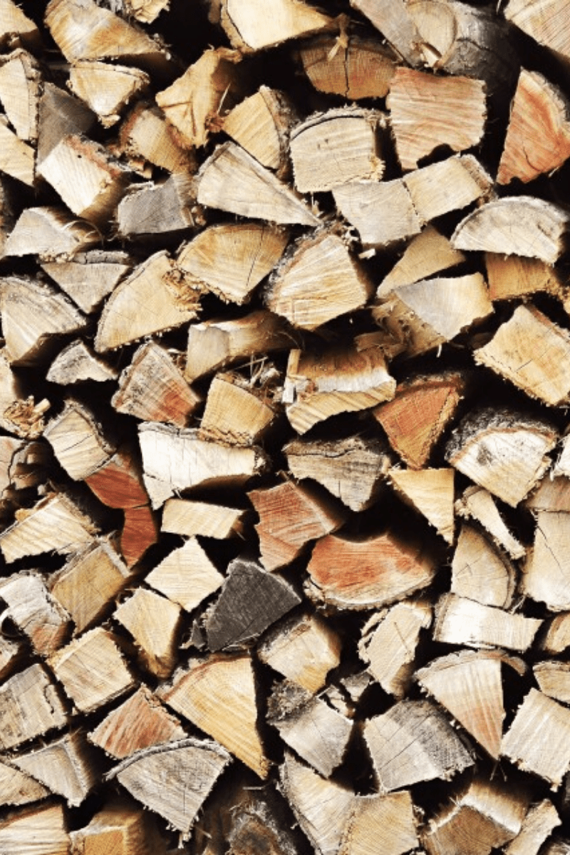 processed seasoning firewood tall split logs from end