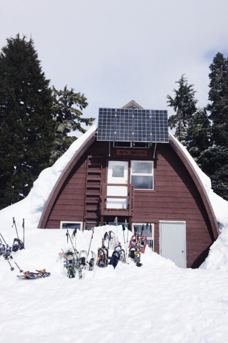 solar panels on the side of a house with snow on the ground