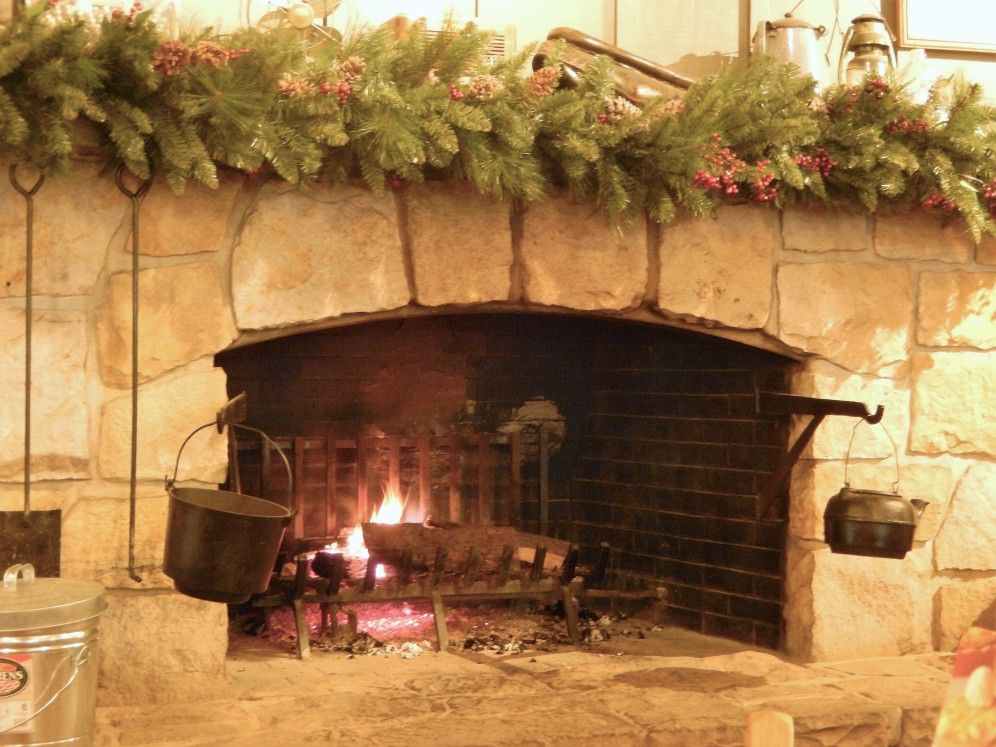 woodfire burning indoor fireplace decorated for christmas