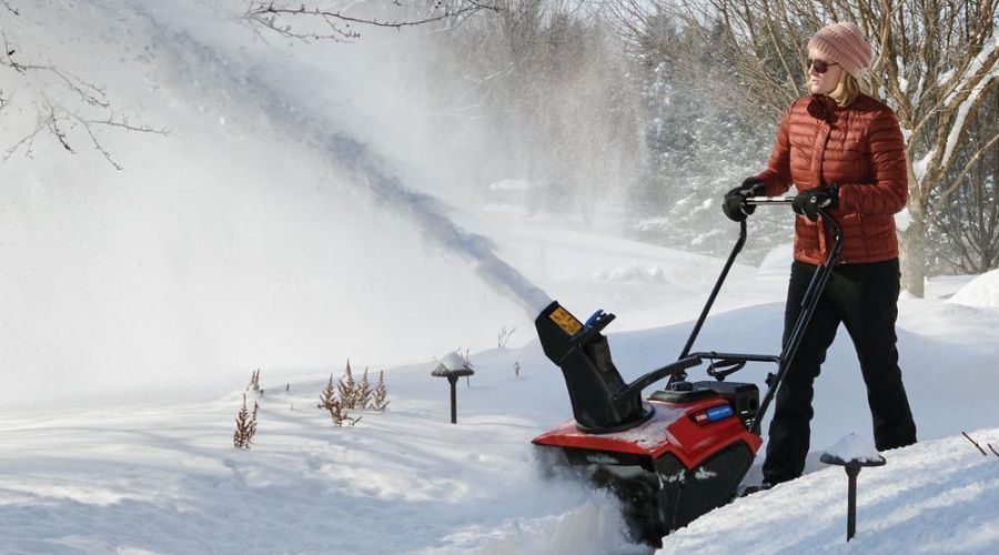 Commercial grade Toro snow blower operated by a woman.