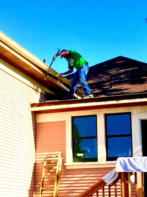 a man installs new gutter guards himself on a home