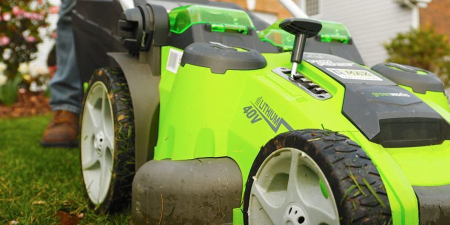 A Greenworks electric cordless twin force lawn mower doing its job.