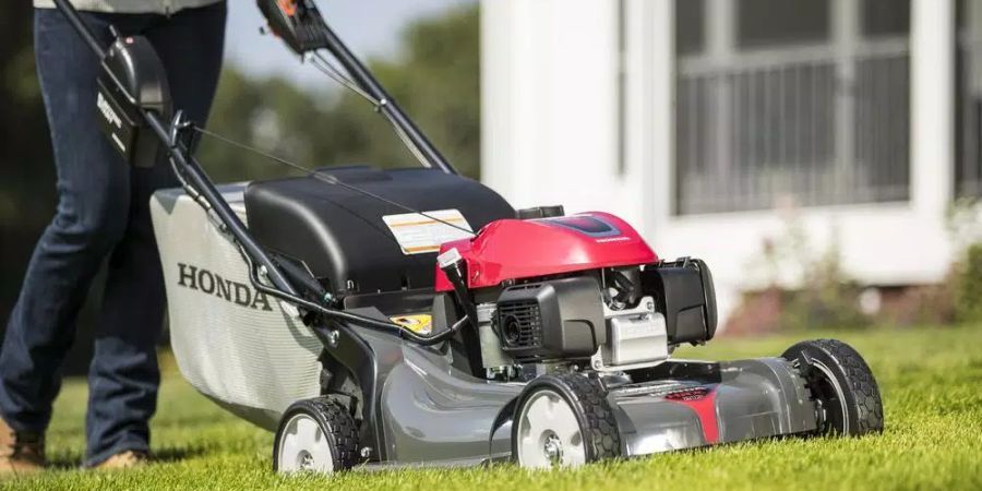 Woman mowing her lawn with a HRX NeXite self-propelled lawn mower.