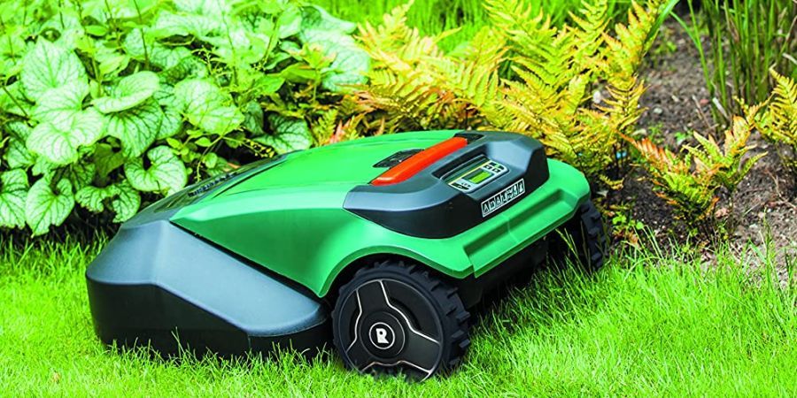 A Robowmow robotic lawn mower making its round along a flower bed.