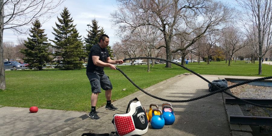 man using battle ropes for workout