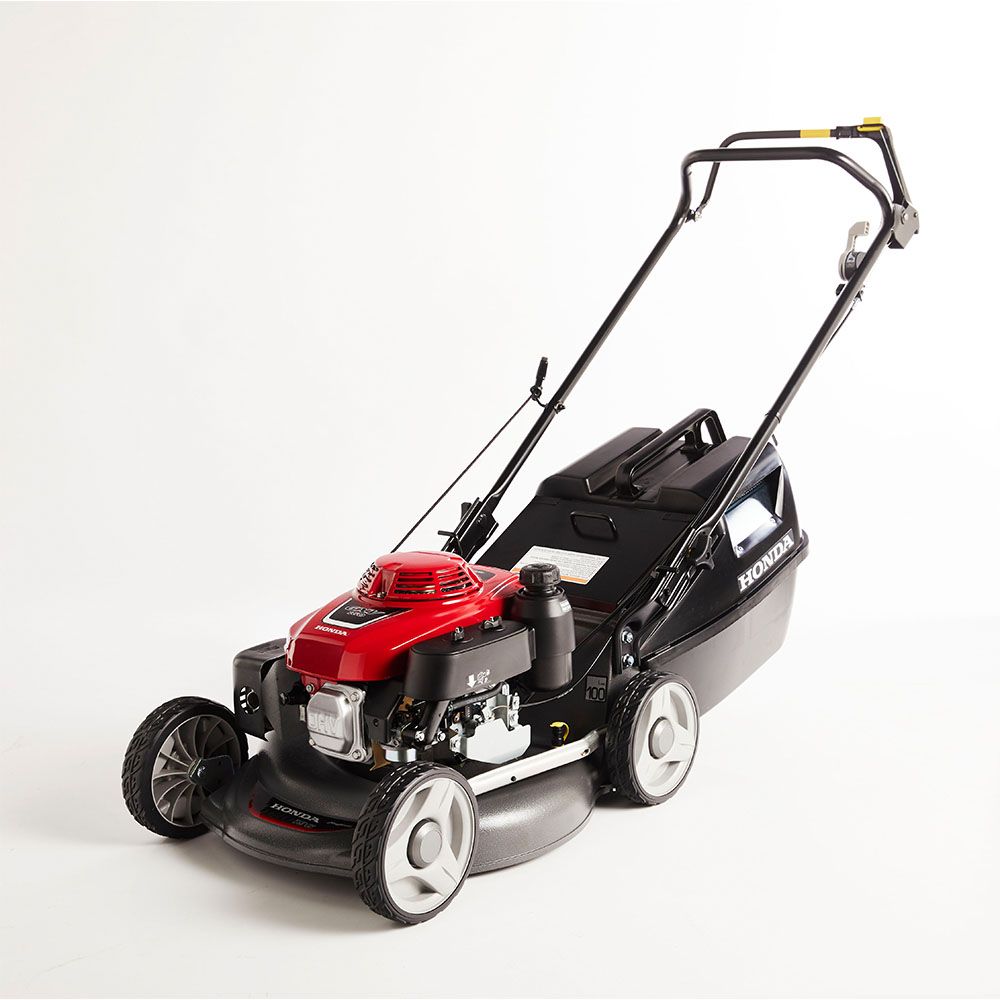 A grey and red Honda walk-behind lawn mower with a grey and black hopper attached.